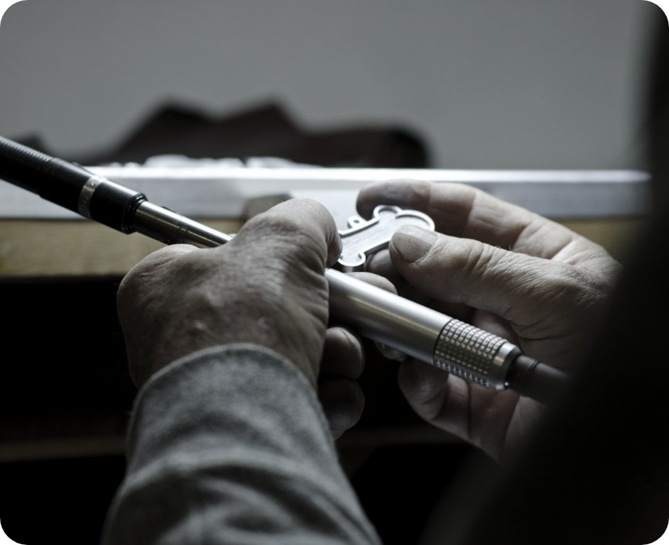 Artisan hands at work on a MyFamily dog tag